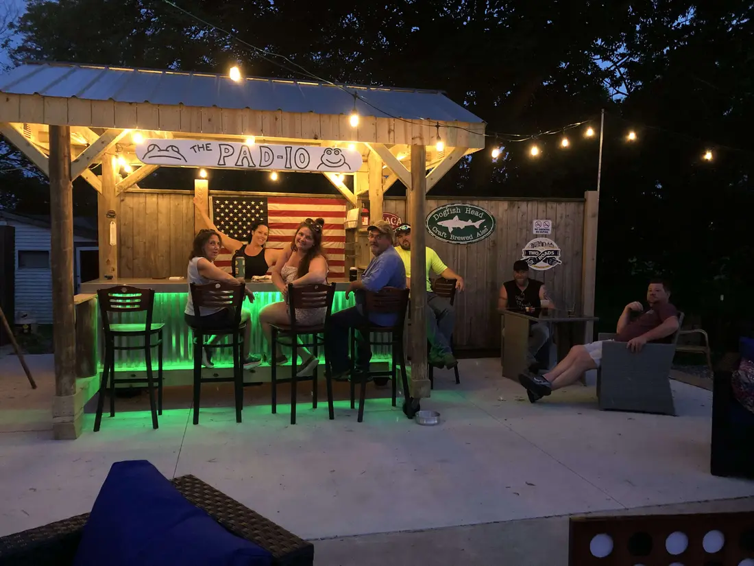 The Pad-io — Frogtown's outdoor bar lit up at dusk with string lights